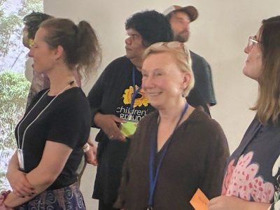 Robyn Sloggett smiling surrounded by people
