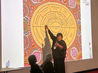 Veronica speaking in front of presentation